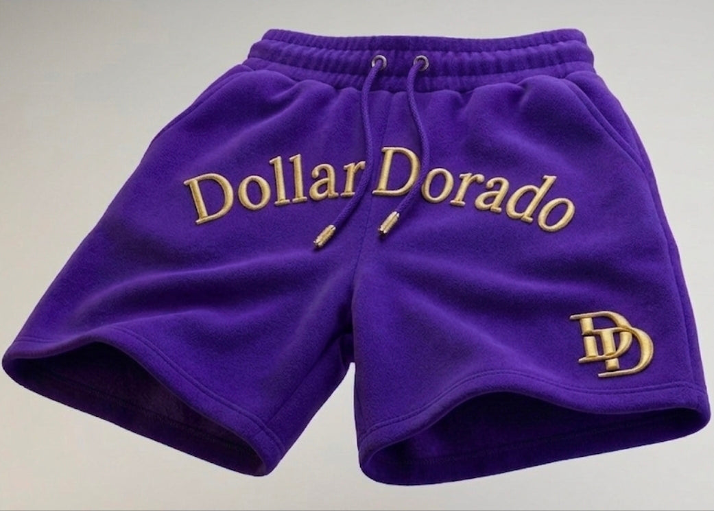 "DollarDorado" shorts (thick fleece). Logo and "DD" lettering embroidered in gold thread. Laces with gold metal tips. Navy blue (15 units available). 2 sizes S, 5 sizes M, 8 sizes L. Limited edition. Limited purple sizes: 3 small, 5 medium, 7 large